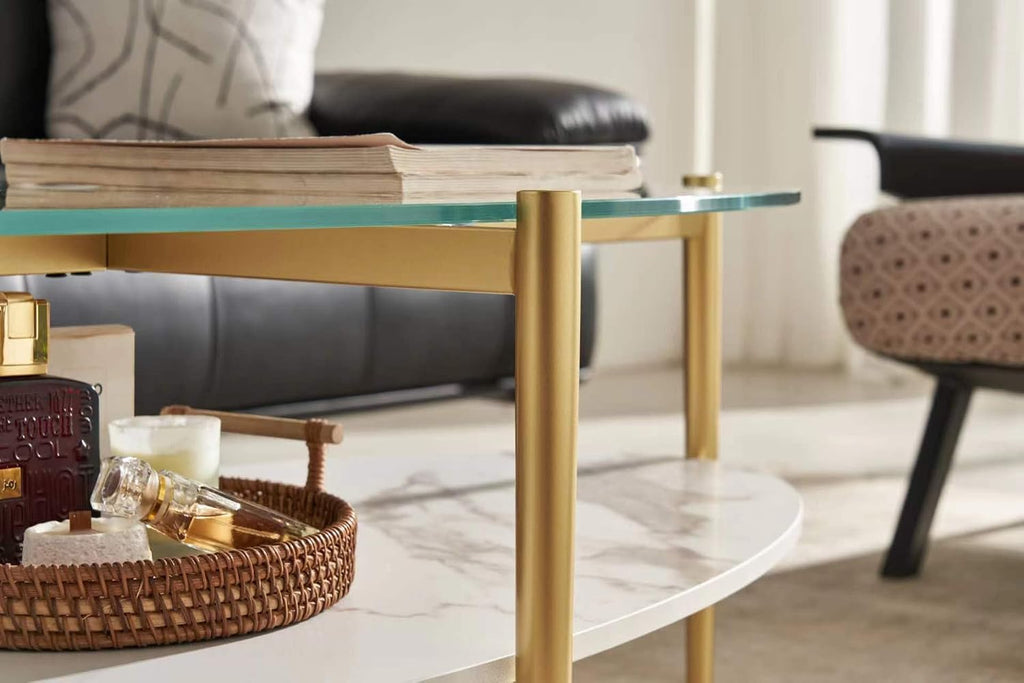 Shrine Oval Coffee Table, Mid-Century Modern Design, 2-Tier Structure, Clear Glass Top and White MDF Shelf, 47" D x 21" W x 17" H, Sleek Conical Metal Legs with Gold Finish