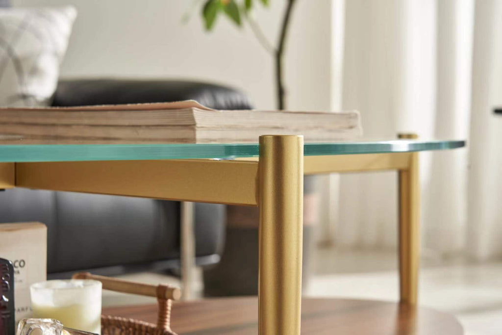 Shrine Oval Coffee Table, Mid-Century Modern Design, 2-Tier Structure, Clear Glass Top and White MDF Shelf, 47" D x 21" W x 17" H, Sleek Conical Metal Legs with Gold Finish
