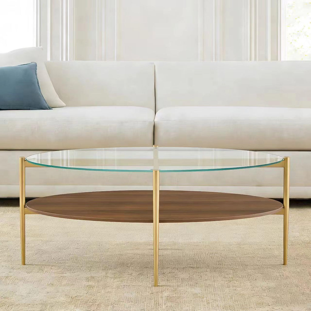 Shrine Oval Coffee Table, Mid-Century Modern Design, 2-Tier Structure, Clear Glass Top and White MDF Shelf, 47" D x 21" W x 17" H, Sleek Conical Metal Legs with Gold Finish