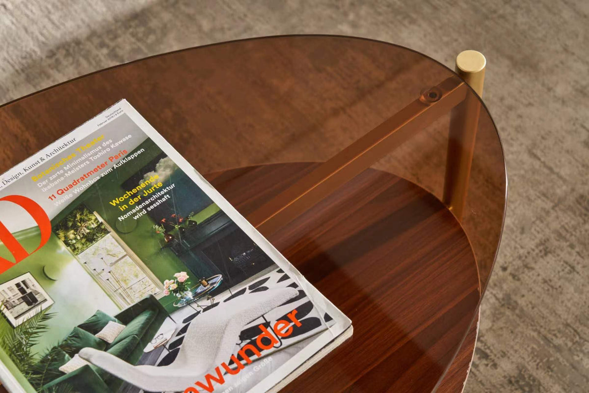 Shrine Oval Coffee Table, Mid-Century Modern Design, 2-Tier Structure, Clear Glass Top and White MDF Shelf, 47" D x 21" W x 17" H, Sleek Conical Metal Legs with Gold Finish