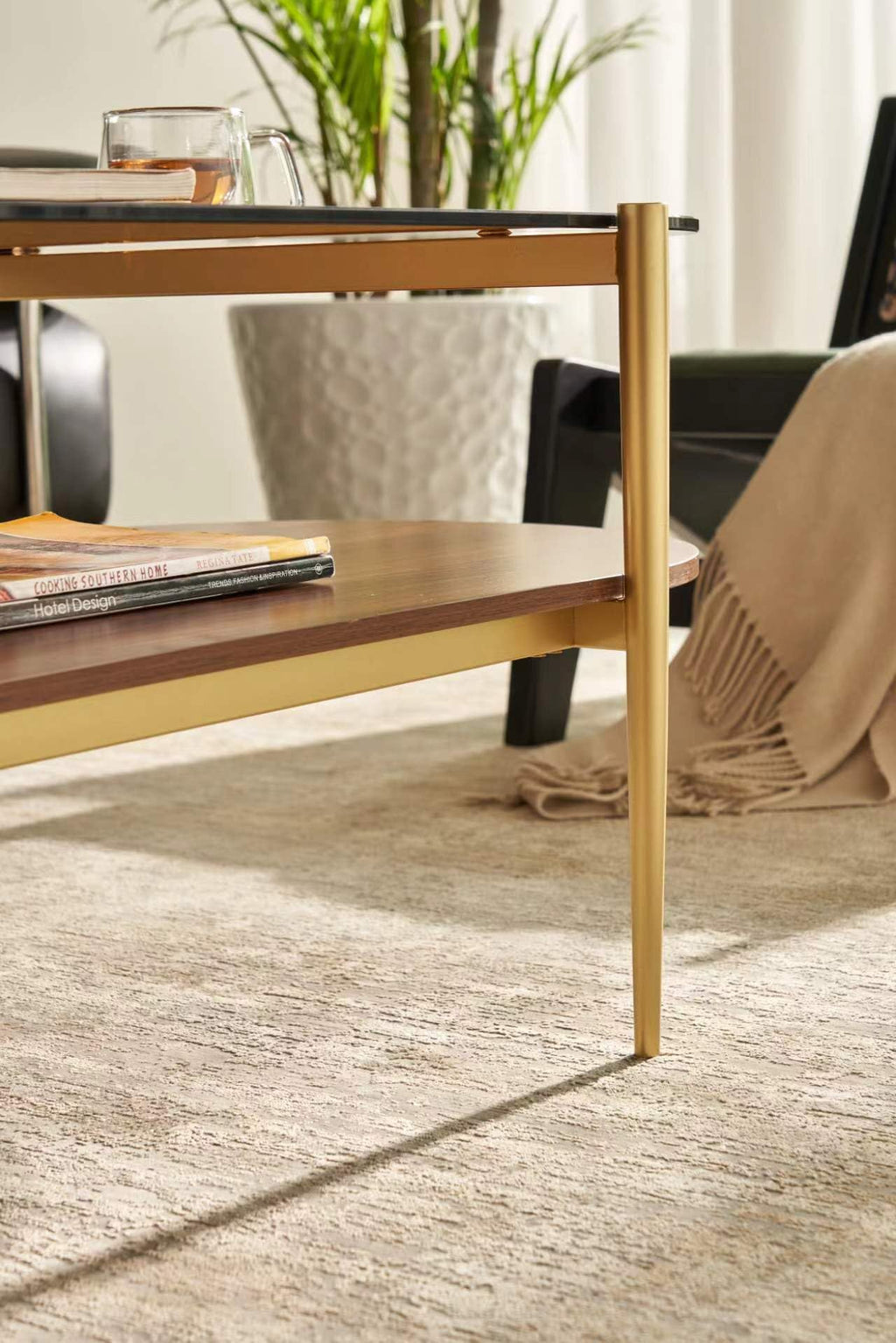 Shrine Oval Coffee Table, Mid-Century Modern Design, 2-Tier Structure, Clear Glass Top and White MDF Shelf, 47" D x 21" W x 17" H, Sleek Conical Metal Legs with Gold Finish