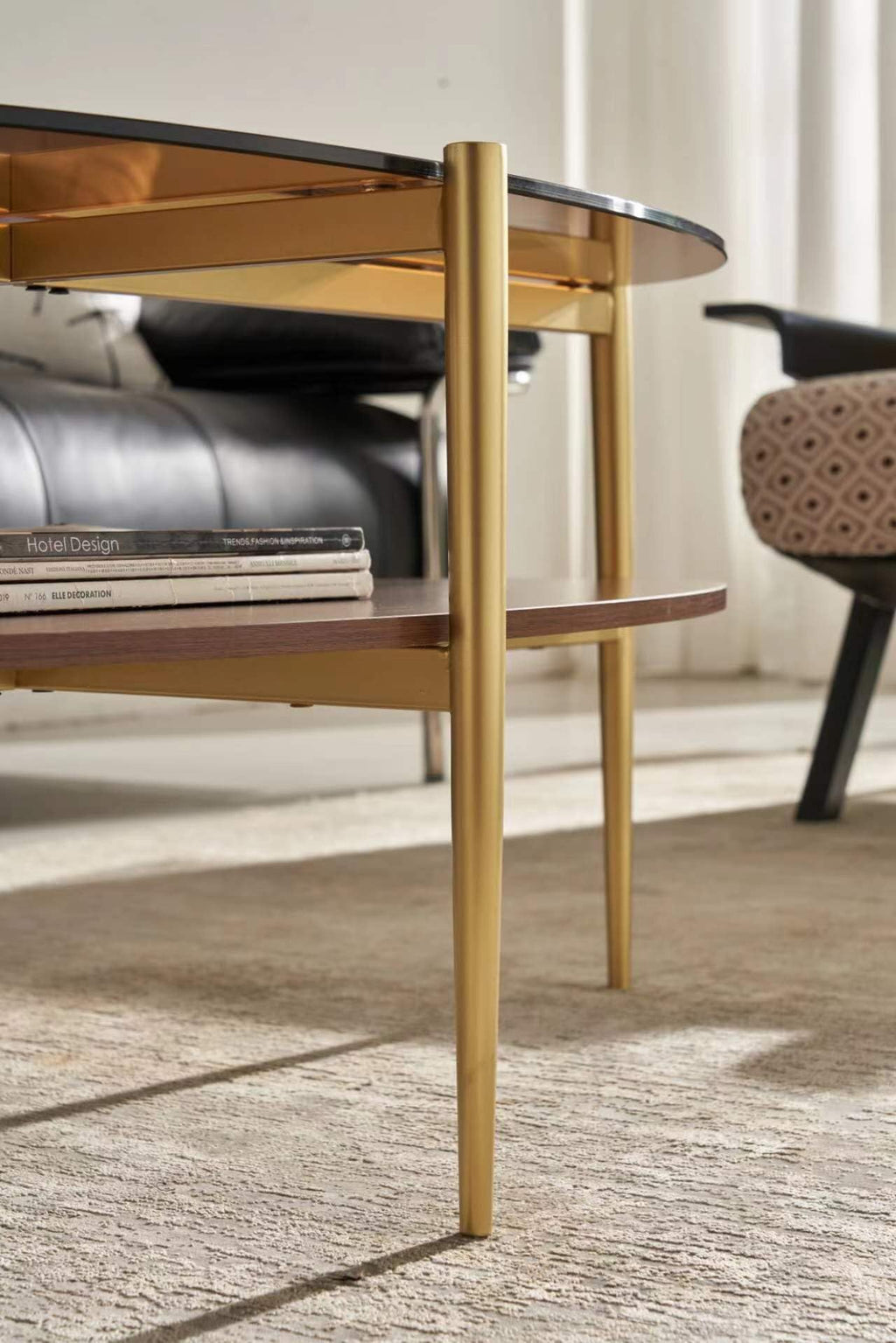 Shrine Oval Coffee Table, Mid-Century Modern Design, 2-Tier Structure, Clear Glass Top and White MDF Shelf, 47" D x 21" W x 17" H, Sleek Conical Metal Legs with Gold Finish