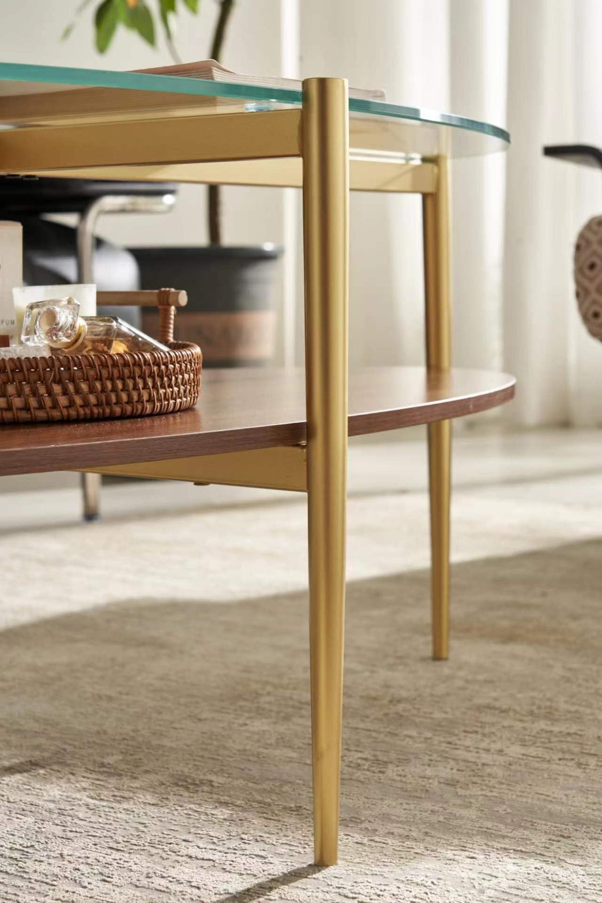 Shrine Oval Coffee Table, Mid-Century Modern Design, 2-Tier Structure, Clear Glass Top and White MDF Shelf, 47" D x 21" W x 17" H, Sleek Conical Metal Legs with Gold Finish