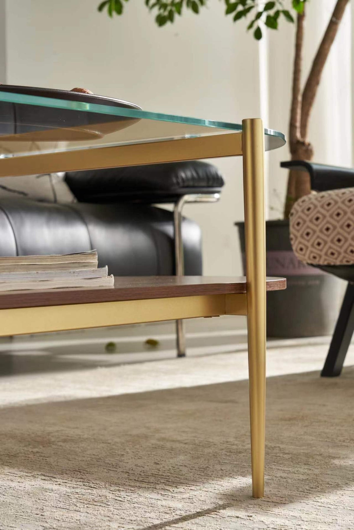 Shrine Oval Coffee Table, Mid-Century Modern Design, 2-Tier Structure, Clear Glass Top and White MDF Shelf, 47" D x 21" W x 17" H, Sleek Conical Metal Legs with Gold Finish