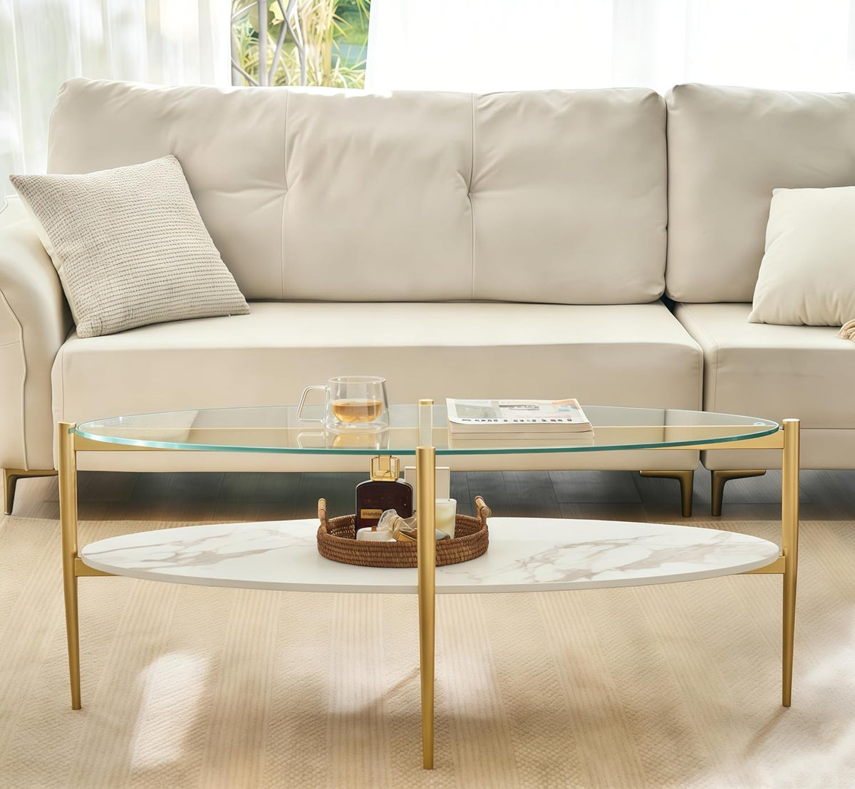 Shrine Oval Coffee Table, Mid-Century Modern Design, 2-Tier Structure, Clear Glass Top and White MDF Shelf, 47" D x 21" W x 17" H, Sleek Conical Metal Legs with Gold Finish