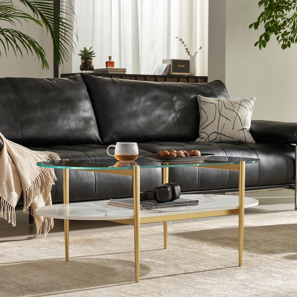 Shrine Oval Coffee Table, Mid-Century Modern Design, 2-Tier Structure, Clear Glass Top and White MDF Shelf, 47" D x 21" W x 17" H, Sleek Conical Metal Legs with Gold Finish